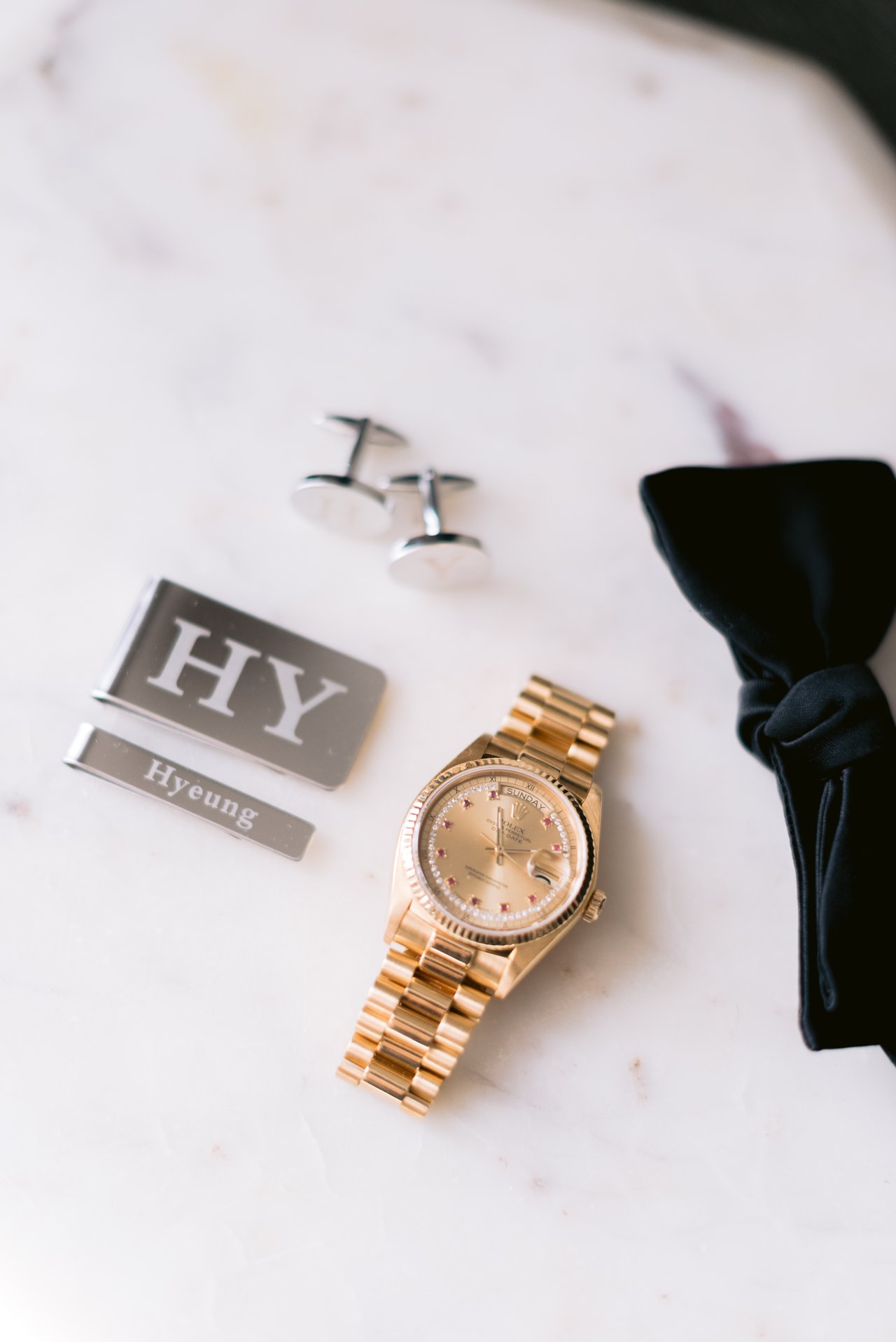 Harry&rsquo;s details &mdash; cufflinks, watch, and bow tie