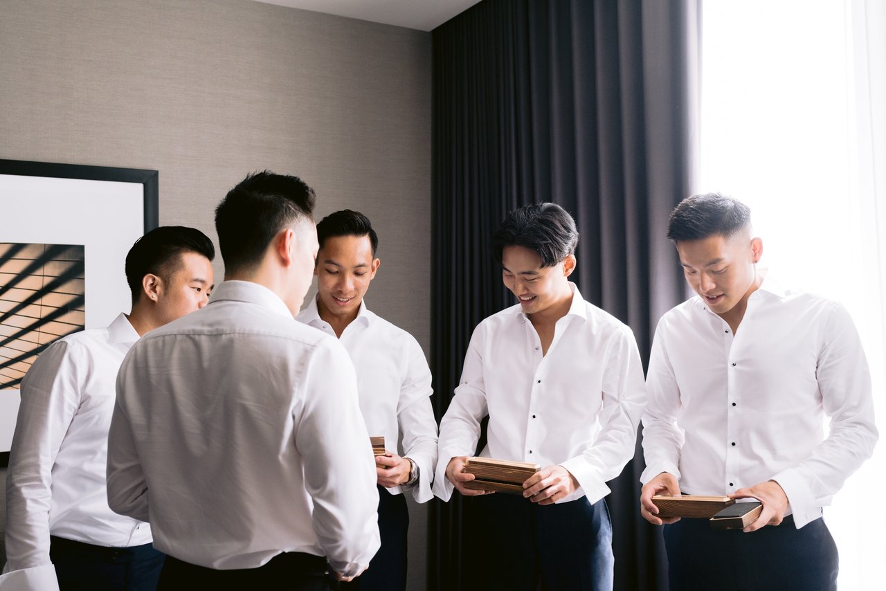 The groomsmen getting ready by the window