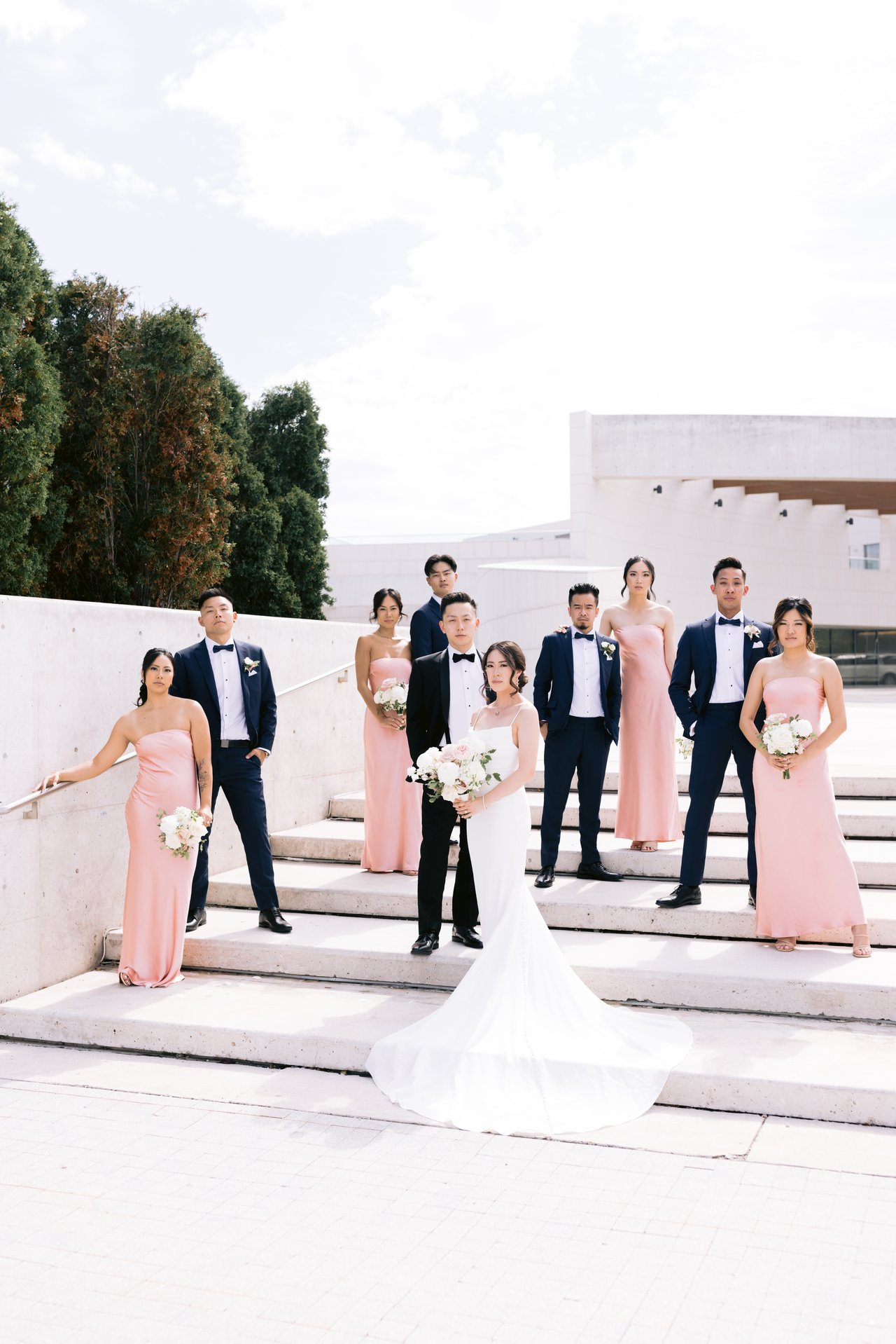 The full wedding party in pink and navy