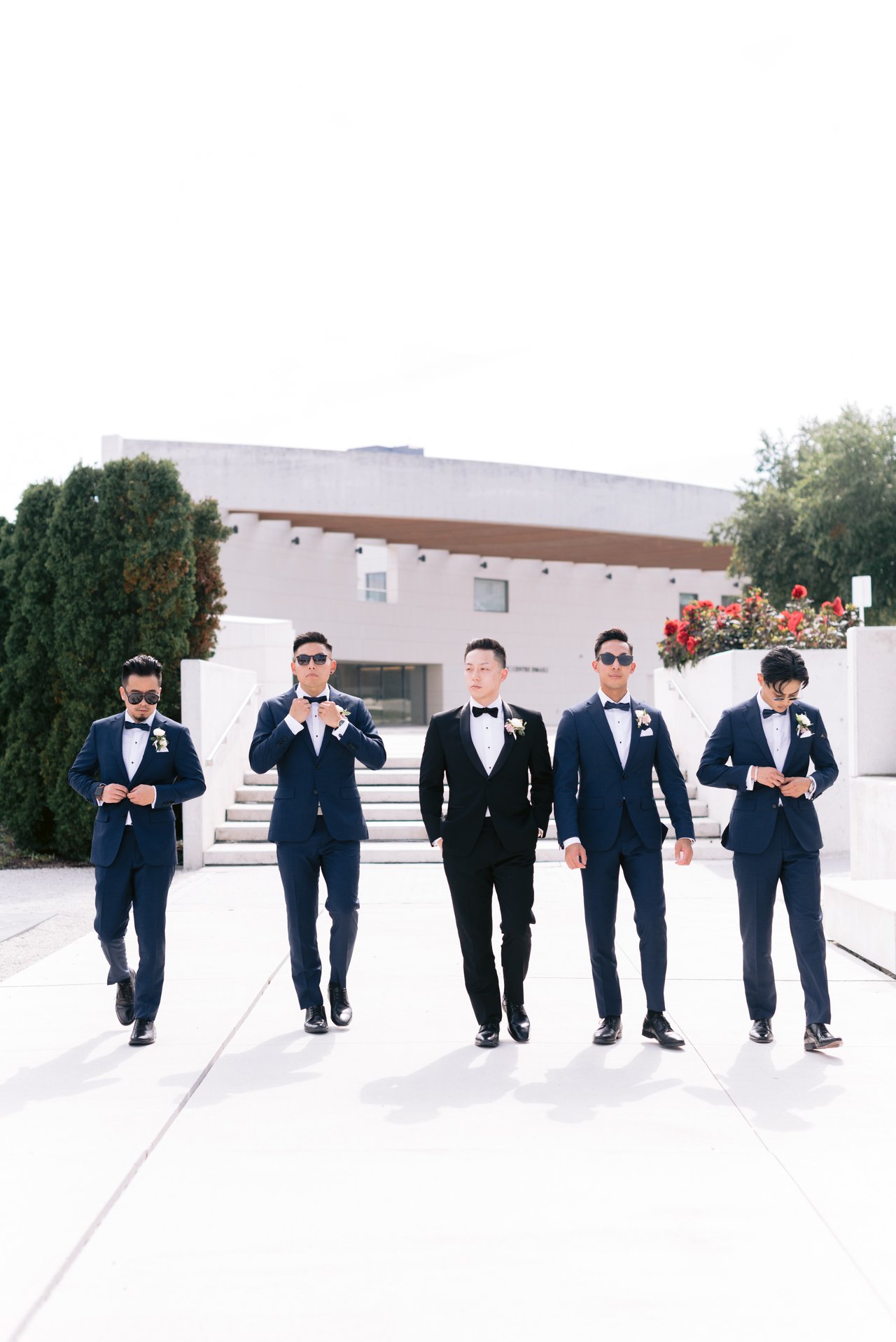 The groomsmen walking, sunglasses on