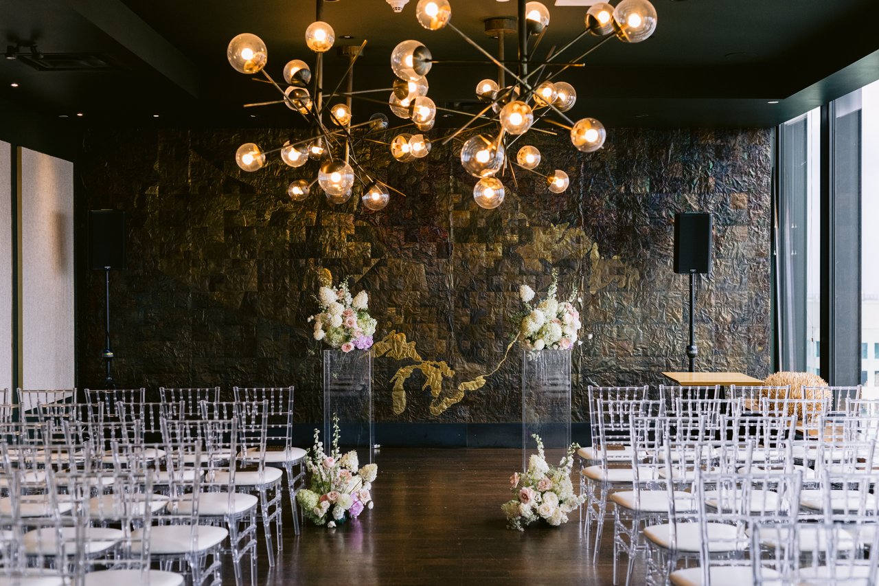 The dining room before the ceremony, chandeliers and dark walls