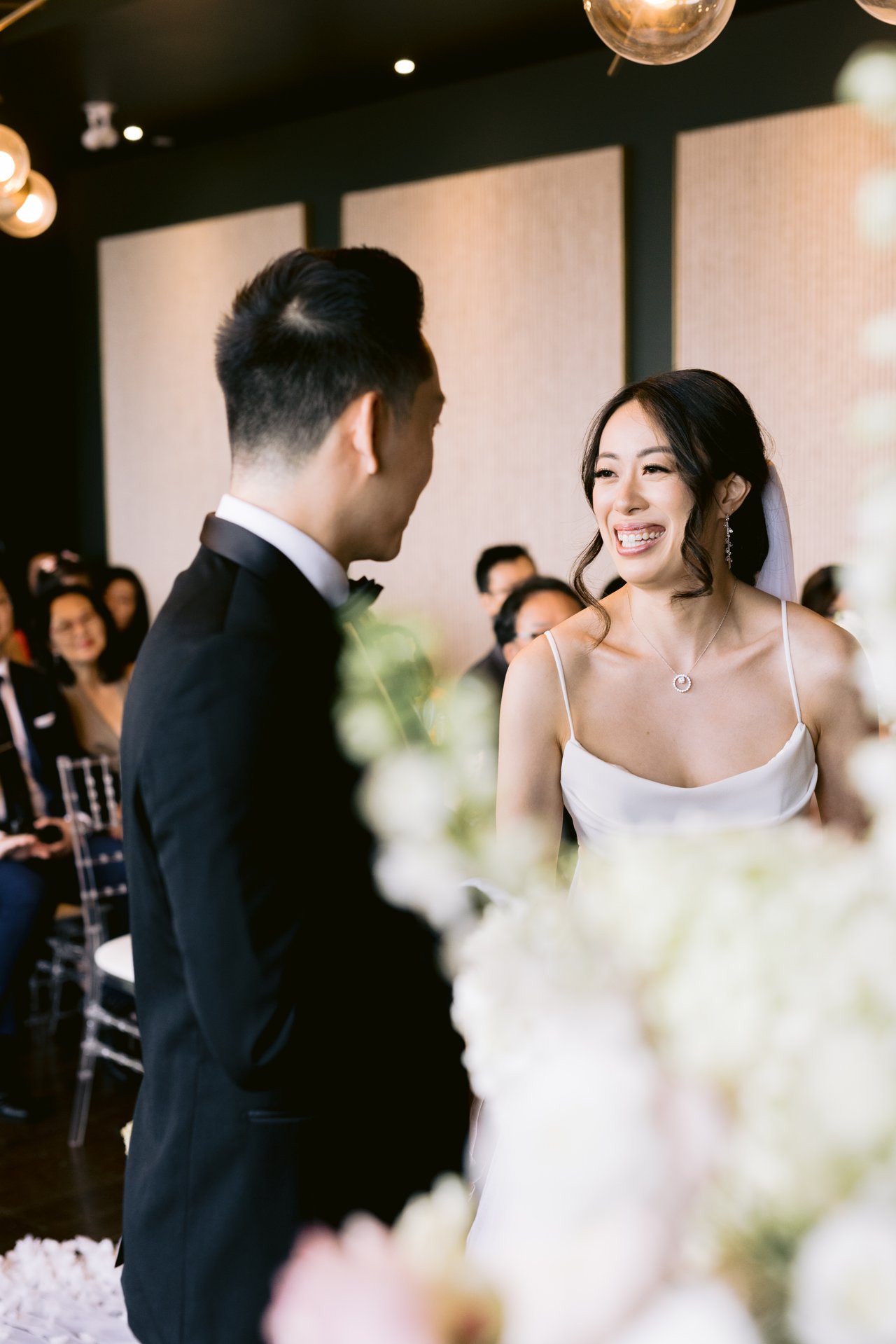 Vows at the altar, florals framing them