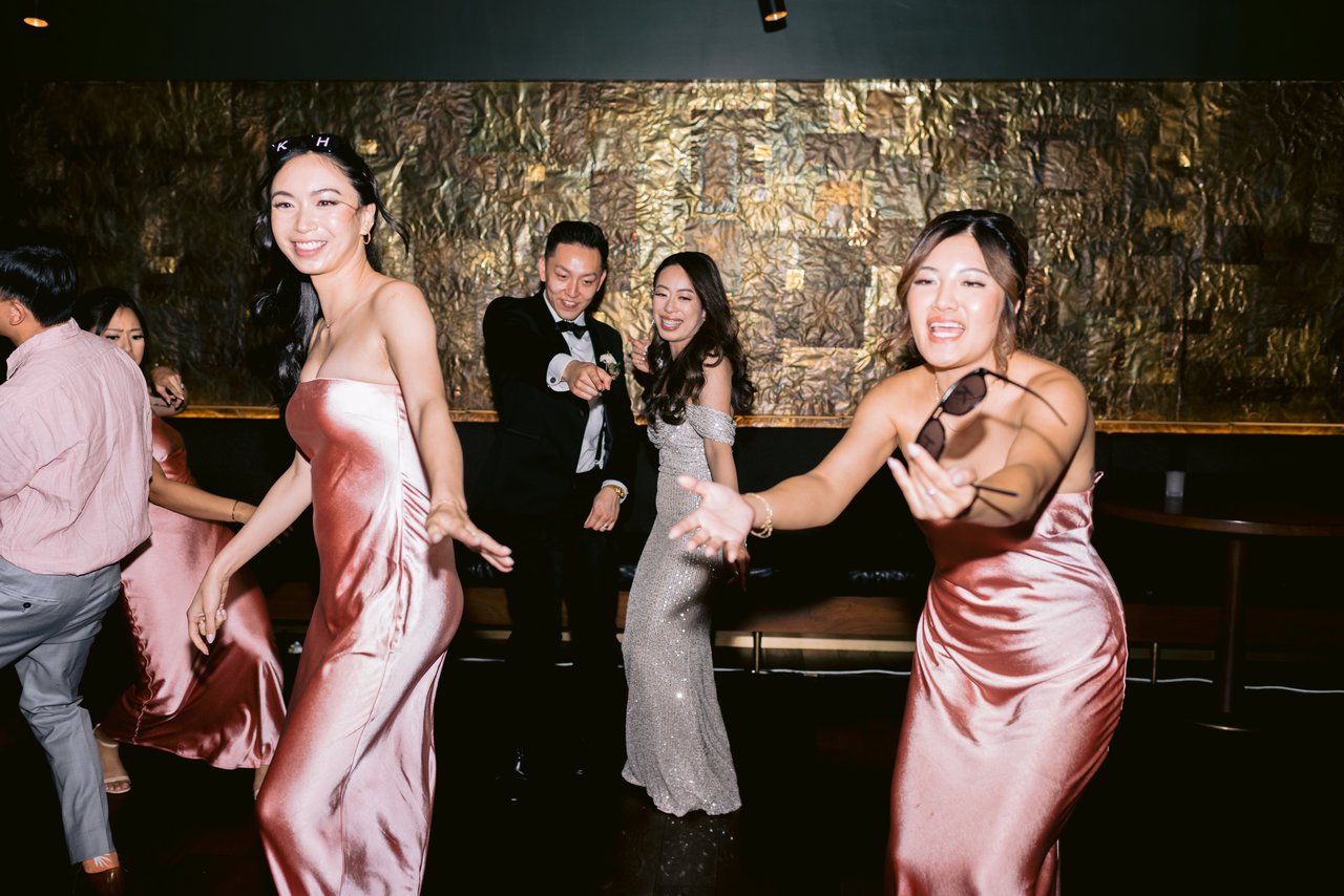 The bridesmaids in satin, mid-twirl