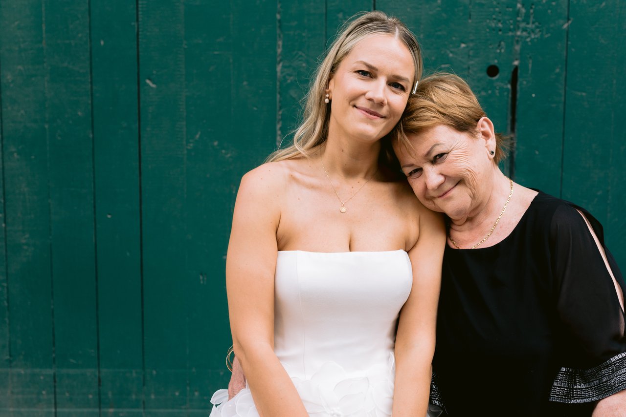 Magda and a bridesmaid by the green wall