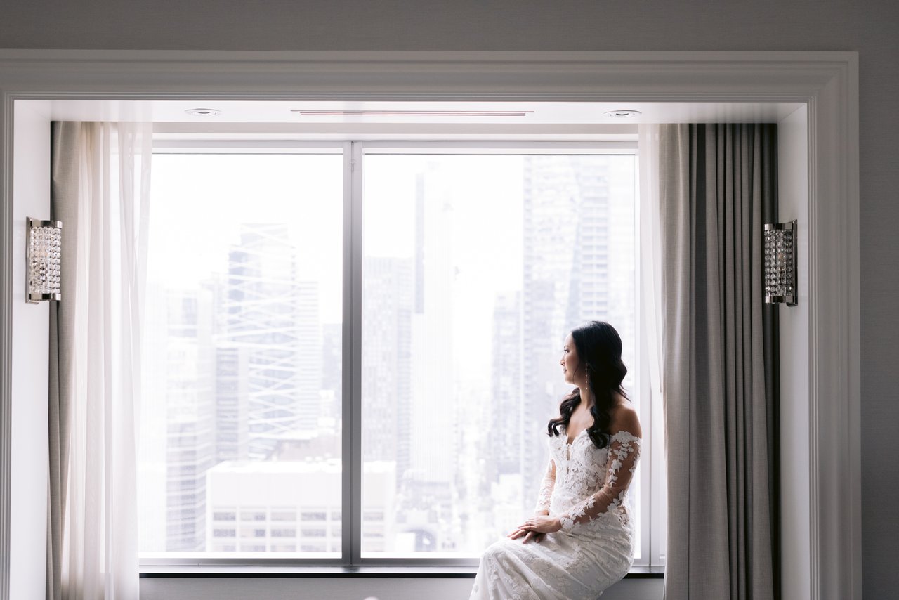 Stella at the window, the city behind her