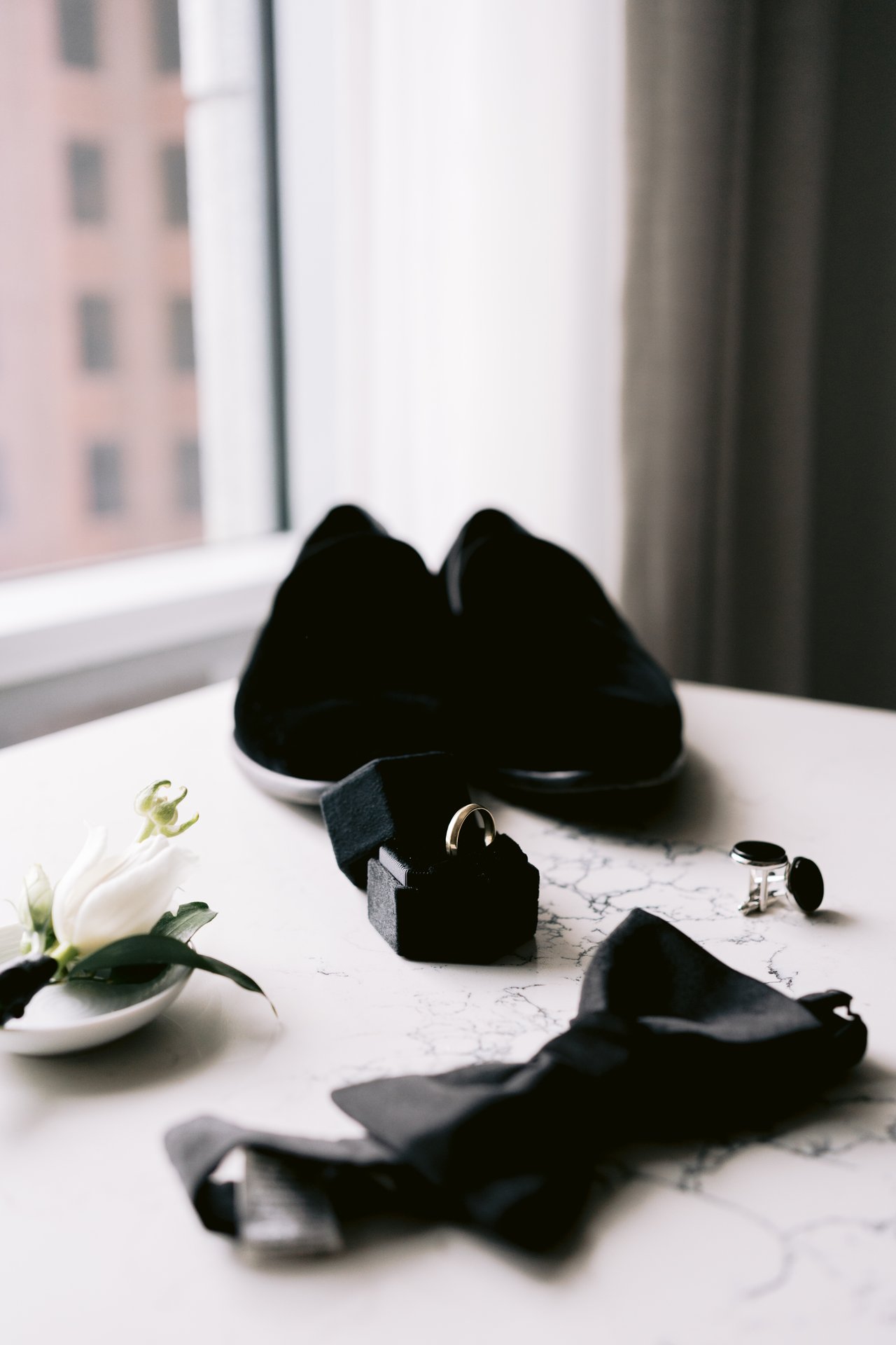 Will&rsquo;s shoes and boutonniere by the window
