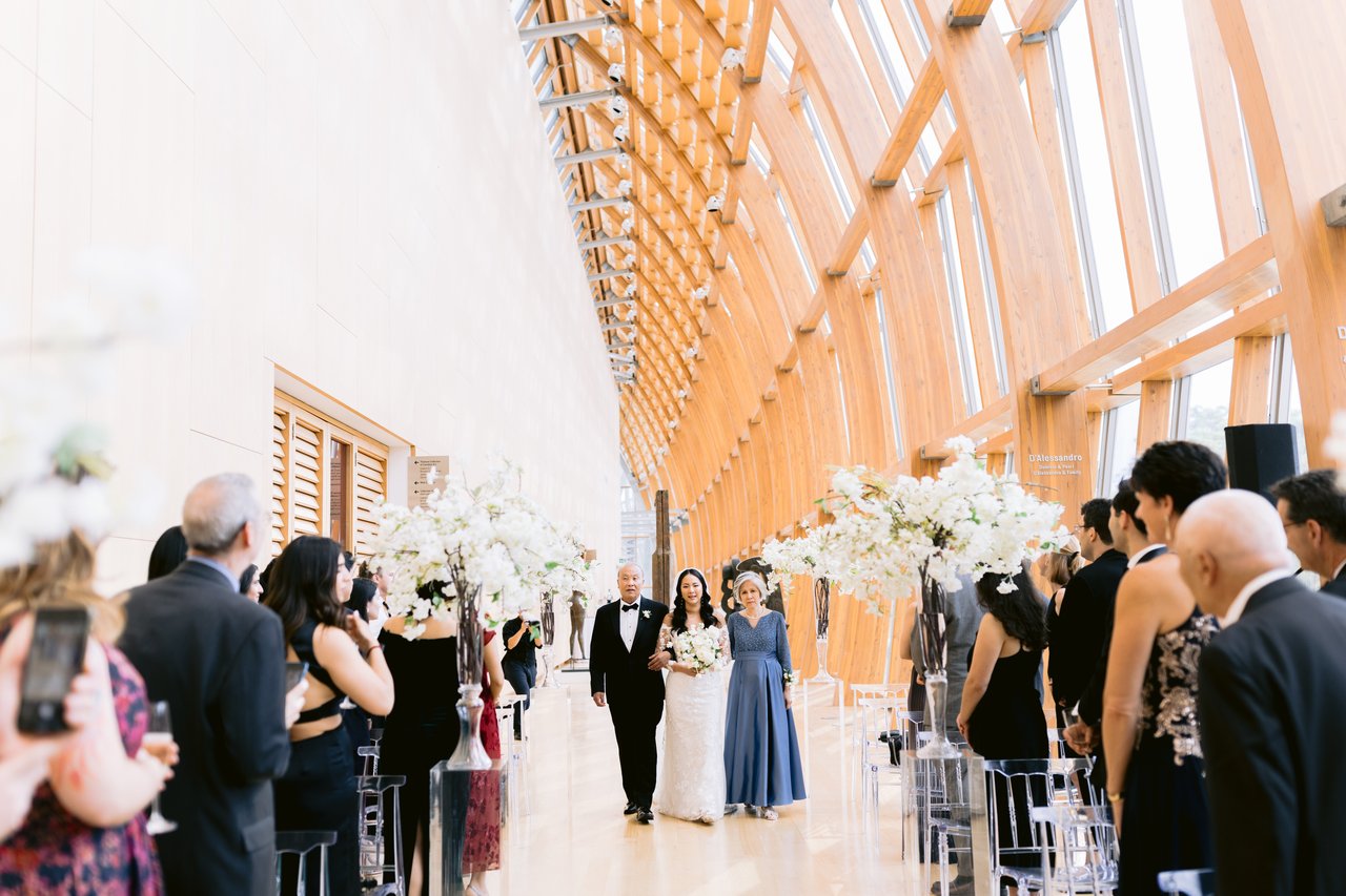 The ceremony beneath the wood and glass