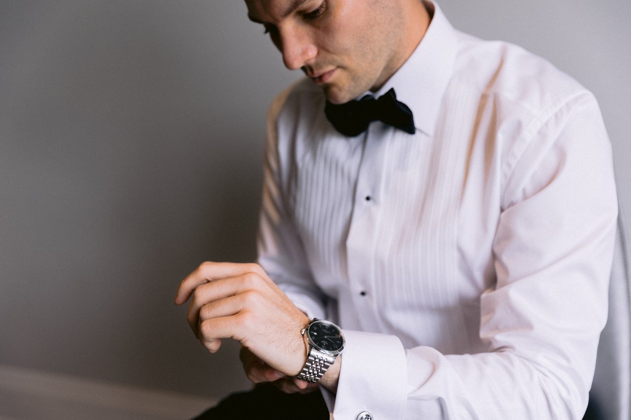 Jordan fixing his cufflinks