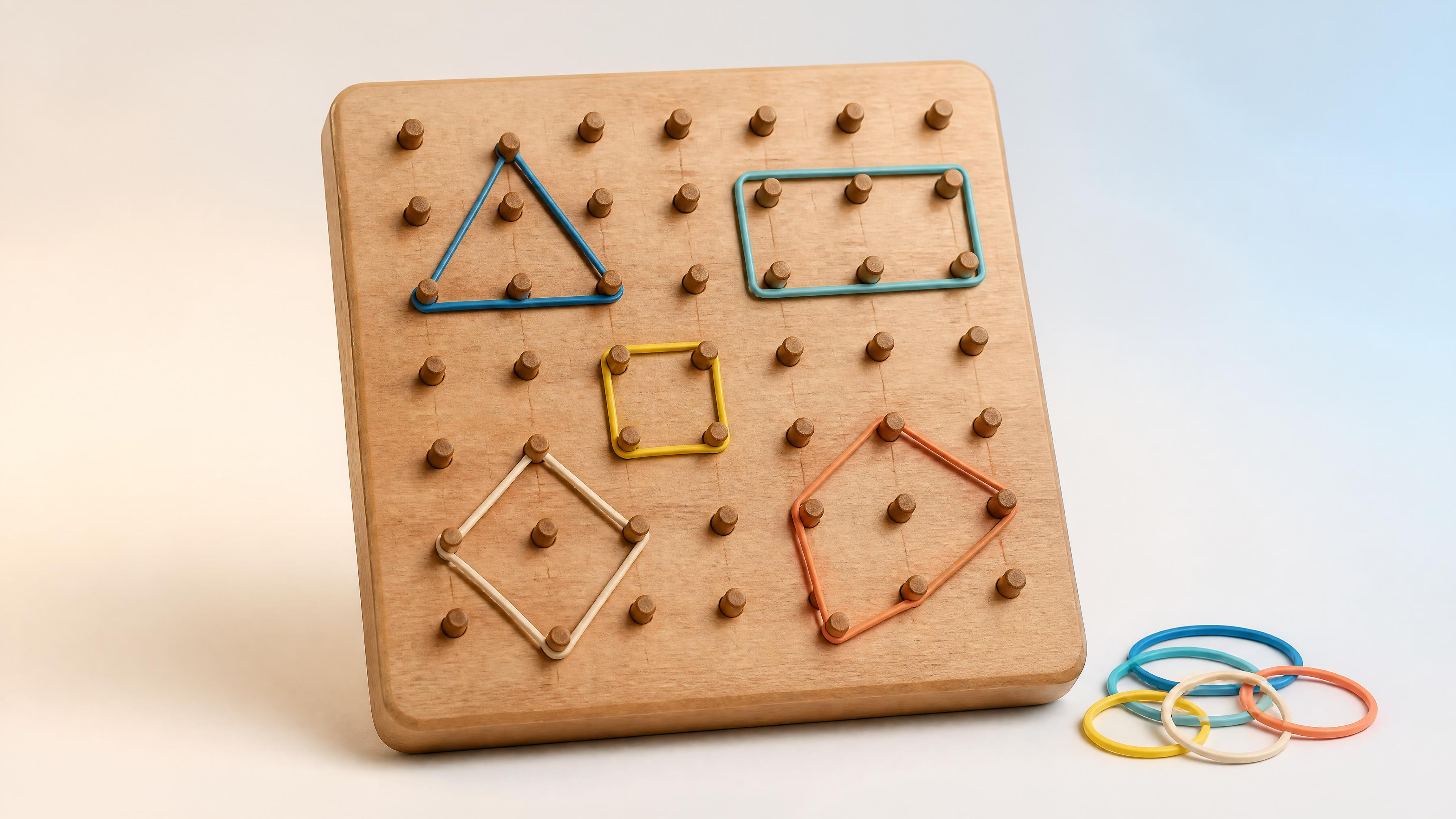 Wooden geoboard with geometric rubber-band shapes