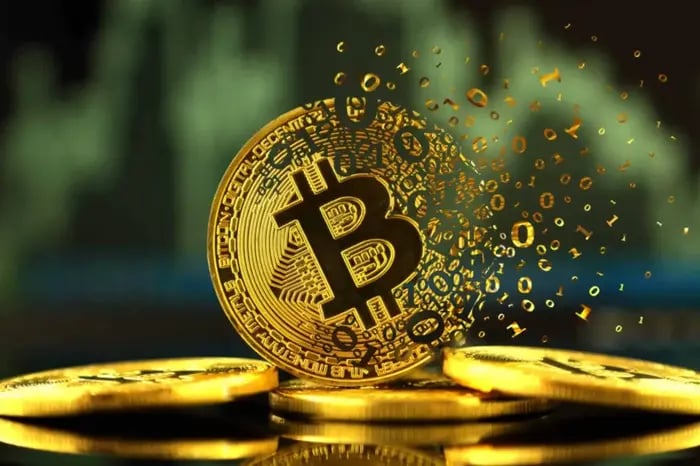 bitcoin golden coin being broken into computer bits