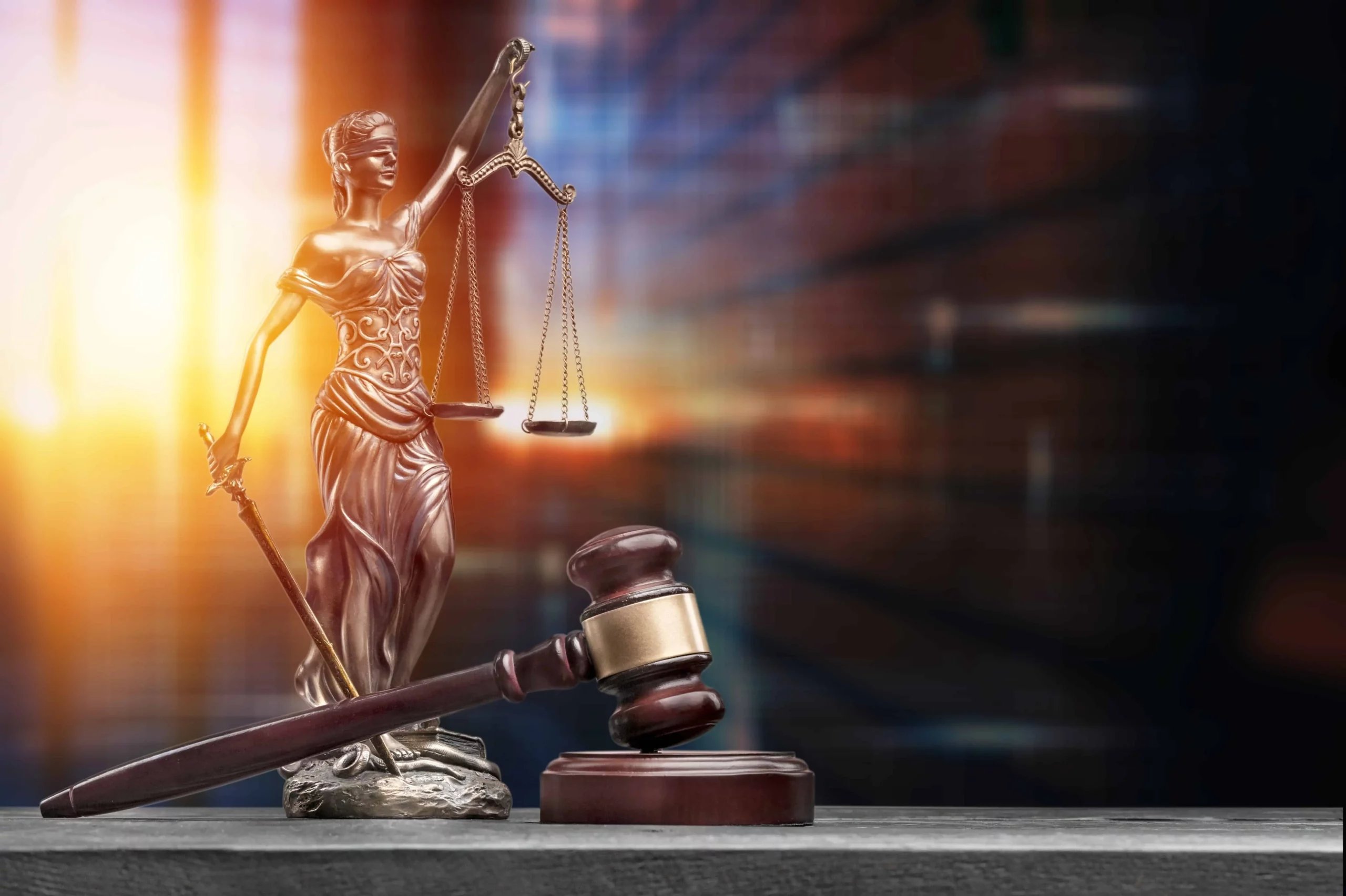 law statue and hammer representing legal process for scams