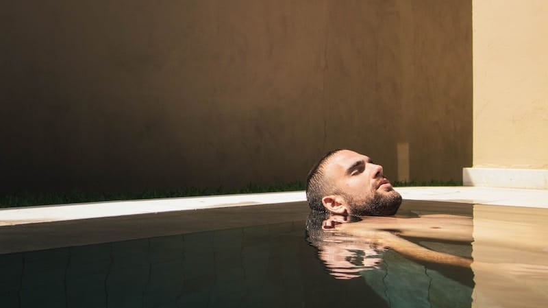 man relaxing in spa setting