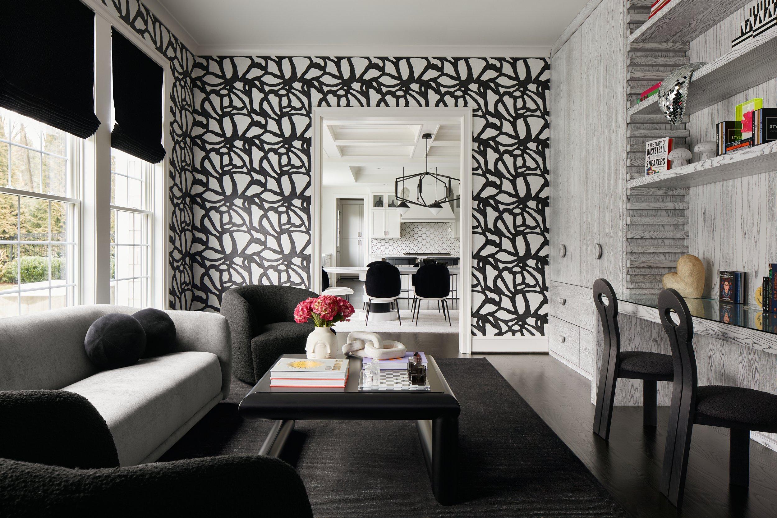 Black-and-white living room with patterned walls and built-in shelving