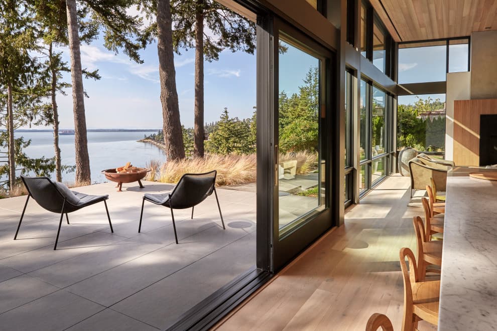 Living room opening onto a waterfront terrace