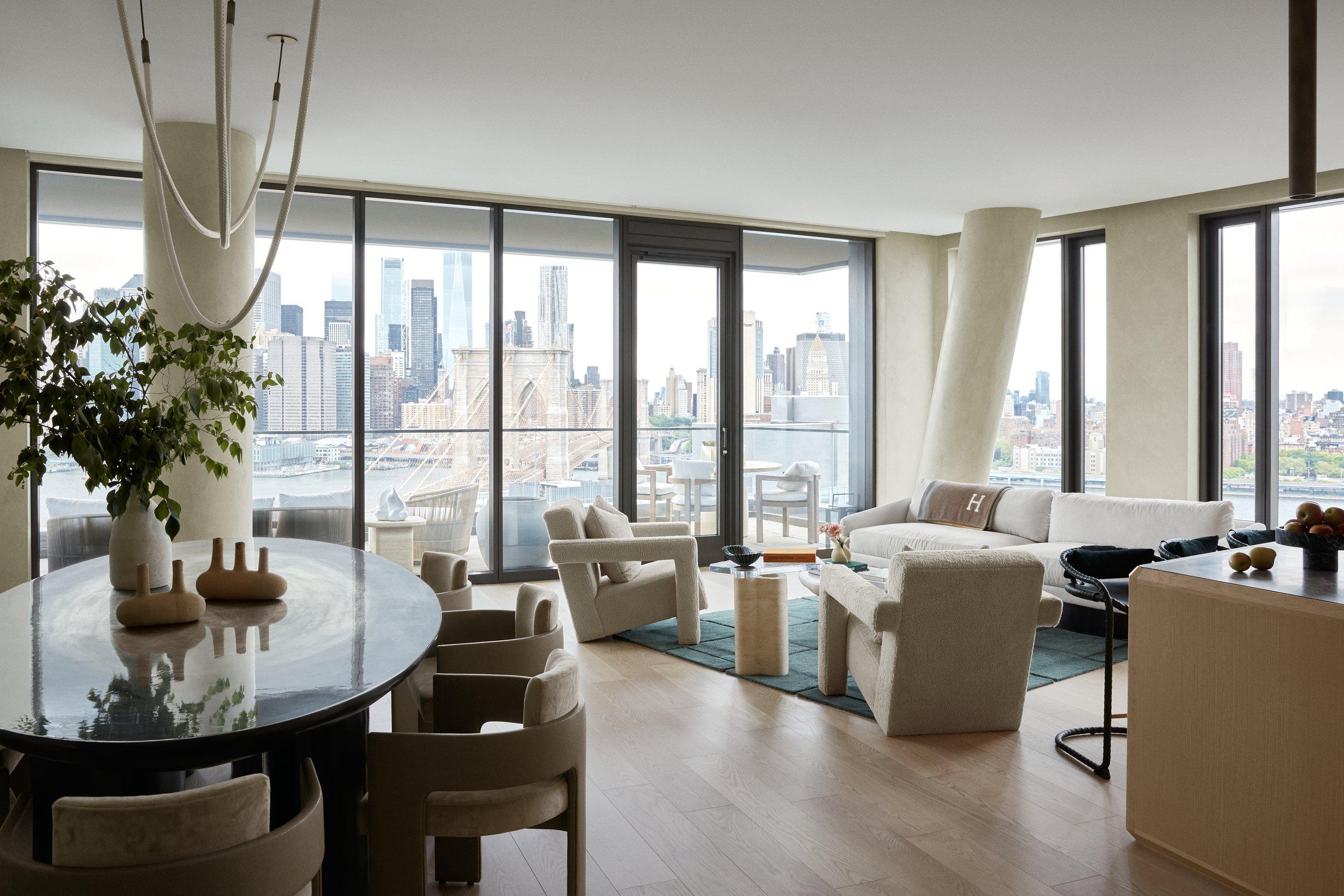 Bright modern apartment with floor-to-ceiling windows and a city skyline view