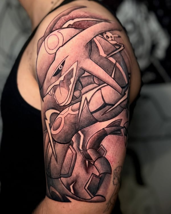 A bold black and grey tattoo of a robotic creature on the upper arm, featuring graphic anime-inspired design — by zealous, los angeles