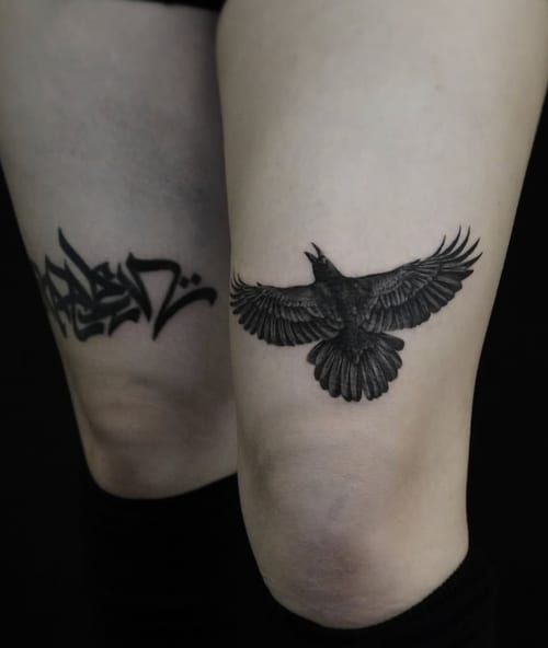 A black and grey realistic depiction of a bird in flight on the thigh, with detailed feather work and shading — by Jian Liang, los angeles