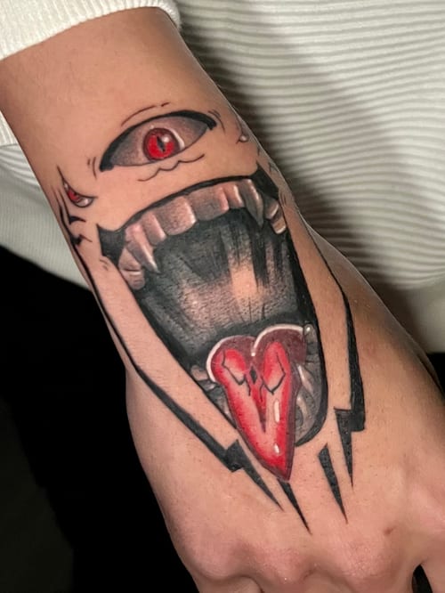 A neo-traditional tattoo on the hand featuring a stylized eye and open mouth with sharp teeth, using a mix of black, grey, and red ink for dramatic effect — by Josue Bravo, los angeles