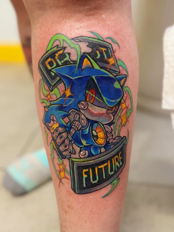 A colorful New School tattoo of a robotic character with vibrant colors and bold outlines on the calf, featuring the words 'PAST' and 'FUTURE' — by Tweetwee, west covina, ca
