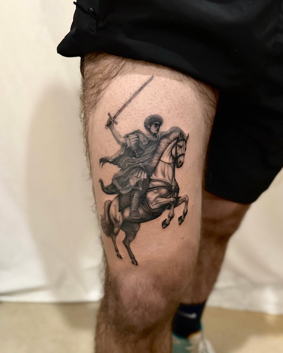 A bold black and grey tattoo of a warrior on horseback wielding a sword, located on the thigh — by otaybeatdown, los angeles