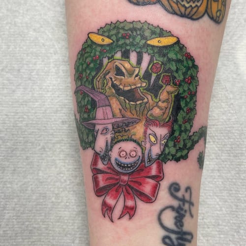 A colorful tattoo featuring whimsical characters surrounded by a wreath on the forearm, done in an illustrative style — by Sandra Price, los angeles