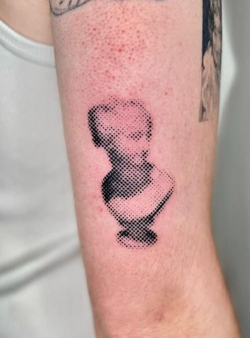 A black and grey dotwork portrait of a bust on the forearm, featuring intricate dot shading and a minimalist style — by Level tattoo, los angeles