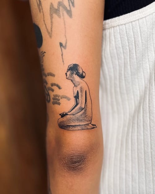 A minimalist black and grey tattoo of a woman sitting on the arm, featuring simple lines and shading — by Dylan Aiello, los angeles