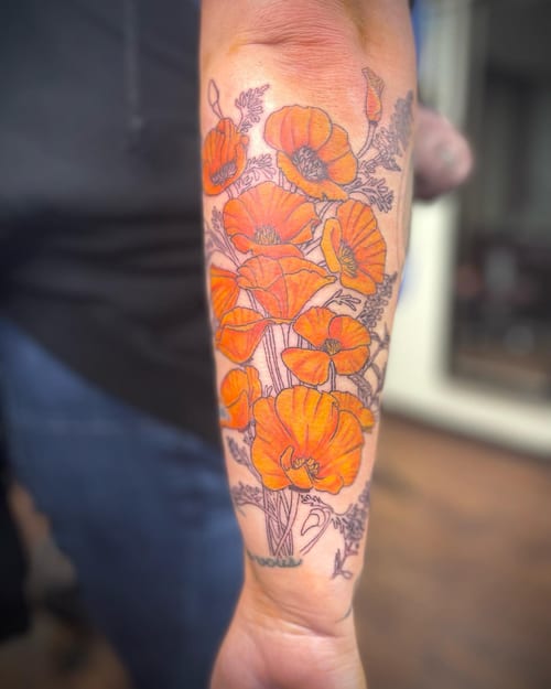 A colorful illustrative tattoo of poppies on the forearm, featuring vibrant orange flowers with delicate linework — by Sandra Price, los angeles