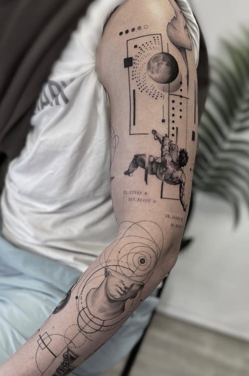 A black and grey tattoo on the arm featuring geometric patterns, a moon, and a surreal depiction of a face with astronomical elements — by Jian Liang, los angeles