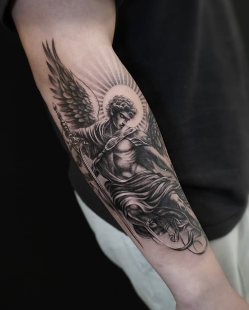 A realistic black and grey tattoo of an angel with a sword on the forearm, featuring detailed shading and a radiant halo — by Jian Liang, los angeles