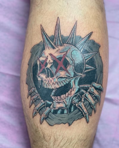 A dark and graphic skull with spikes tattoo on the calf, featuring a neo-traditional style with mixed colors — by Sandra Price, los angeles