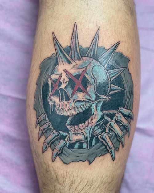 A dark and graphic skull with spikes tattoo on the calf, featuring a neo-traditional style with mixed colors — by Sandra Price, los angeles