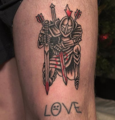 A bold black and grey tattoo of a knight in armor with swords on the thigh, done in a neo-traditional style — by Miguel ANGELO, los angeles