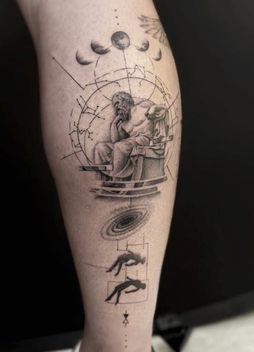 A black and grey tattoo on the calf featuring a realistic depiction of 'The Thinker' surrounded by celestial elements and dotwork details — by Jian Liang, los angeles