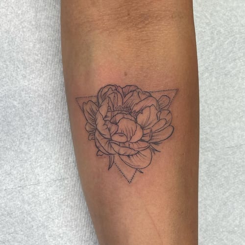 A delicate fine line flower with a geometric triangle on the forearm, featuring minimalist black and grey ink — by Sandra Price, los angeles