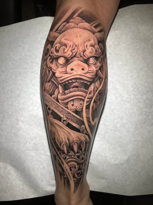 A detailed black and grey realism tattoo of a mythological creature on the calf, featuring intricate shading and texture — by imindisoul, anaheim, ca