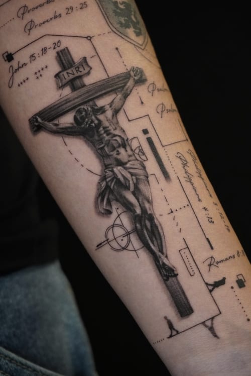 A black and grey realistic depiction of Jesus on the cross with scriptural references and geometric elements on the forearm — by Jian Liang, los angeles