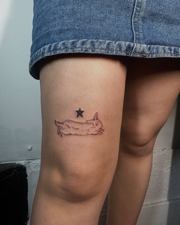 A minimalist black and grey tattoo of a rabbit and star on the thigh, featuring delicate linework — by zealous, los angeles