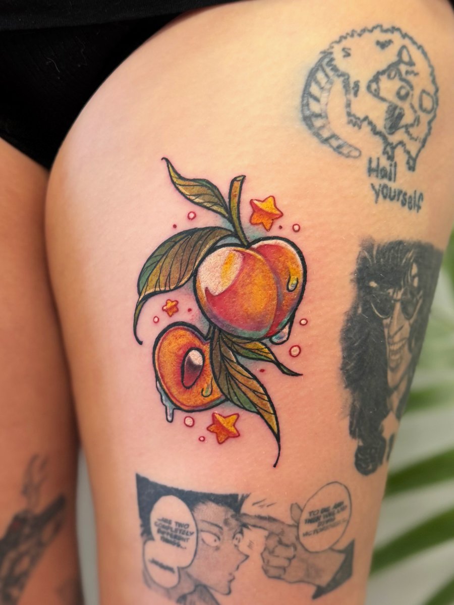 A colorful neo-traditional tattoo of peaches with leaves and small stars on the thigh, featuring bold outlines and vibrant shading — by Tweetwee, los angeles