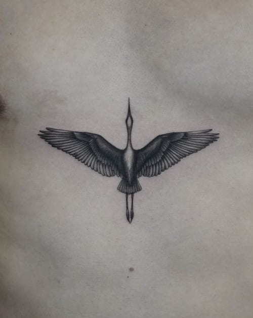A fine line black and grey tattoo of a bird with outstretched wings on the chest, featuring detailed linework and shading — by Jian Liang, los angeles