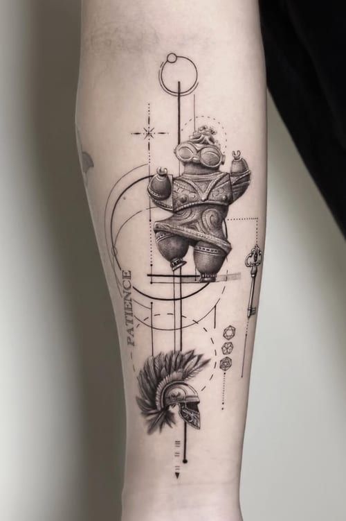 A black and grey geometric and illustrative tattoo on the forearm featuring a stylized figure with a helmet and intricate linework, accompanied by the word 'PATIENCE' — by Jian Liang, los angeles