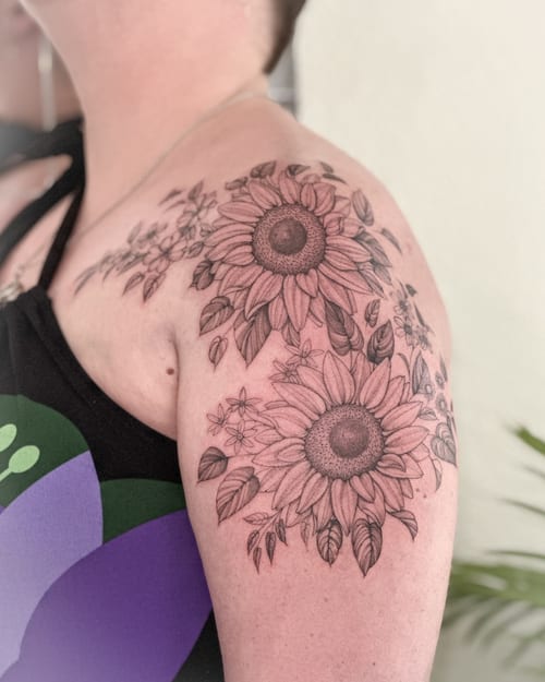 A delicate black and grey sunflower tattoo on the shoulder with intricate floral details — by Melanie Benoit, los angeles
