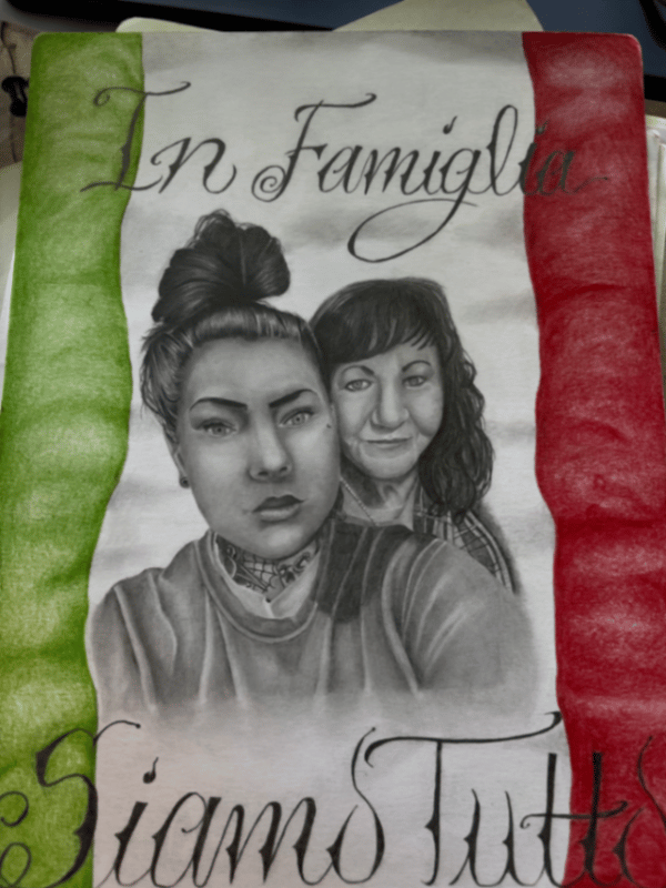 A mixed color tattoo featuring two black and grey portraits with Italian script and the colors of the Italian flag in the background — by christopher diaz, los angeles