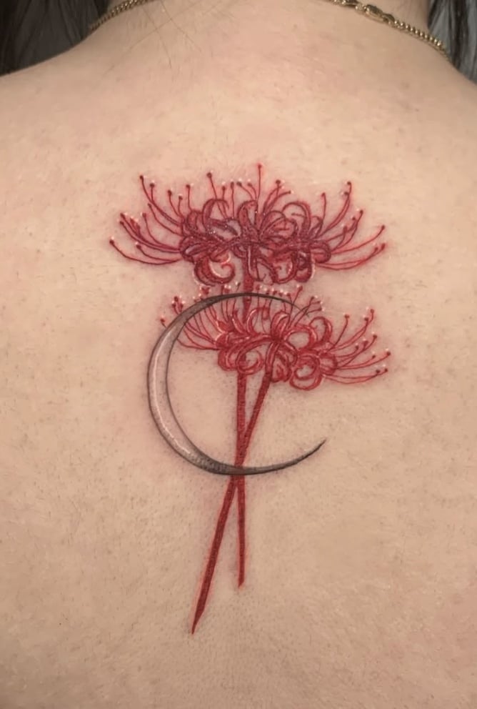 A delicate fine line tattoo on the back featuring red flowers and a crescent moon, with a soft and elegant design — by Shelby Bianco, los angeles