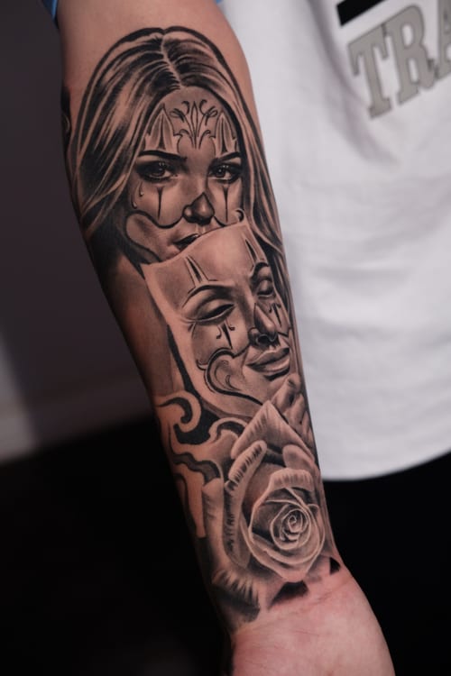 black & grey woman with masks and rose tattoo — by Johnny Ayala, los angeles