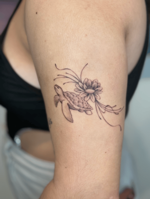 fine line sea turtle with flower tattoo — by Samantha Wilks, los angeles