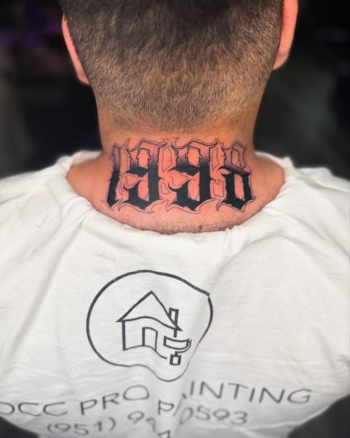 A bold blackwork tattoo of the year 1998 in script lettering on the neck — by zealous, los angeles
