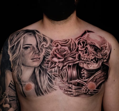 A detailed black and grey tattoo on the chest featuring a woman's portrait alongside a skeleton and rose, showcasing realistic shading and texture — by Johnny Ayala, los angeles
