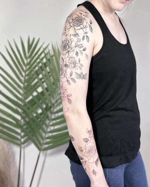 A delicate black and grey rose bouquet tattoo on the arm, featuring fine line work and clean detailing — by Melanie Benoit, los angeles