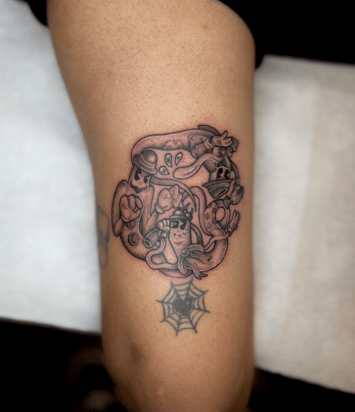 circular cluster of vintage cartoon characters with a spiderweb hanging below, black and grey arm tattoo — by Engram, los angeles